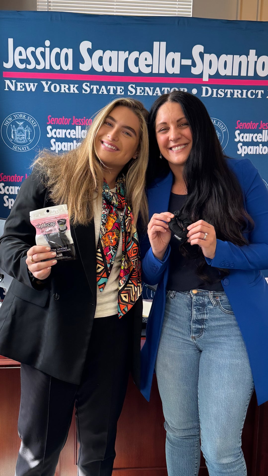 Two women posing with a campaign sign for Jessica Scarcella-Spano in New York State Senate District.